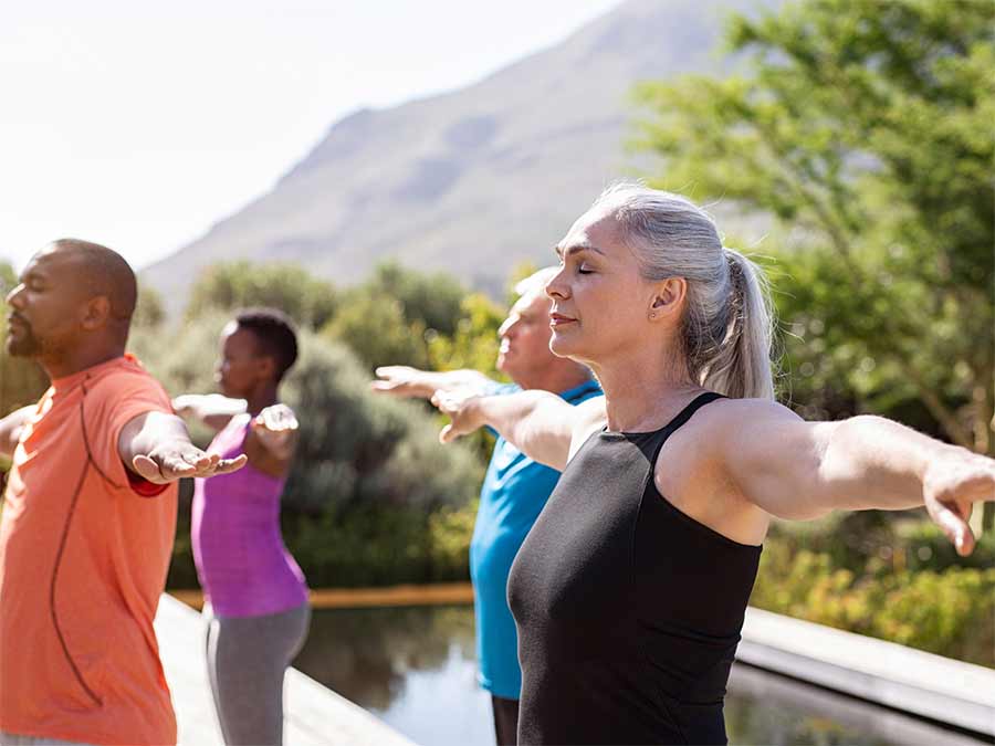 a group practice mindful yoga with one wearing phonak hearing aids with speech sensor