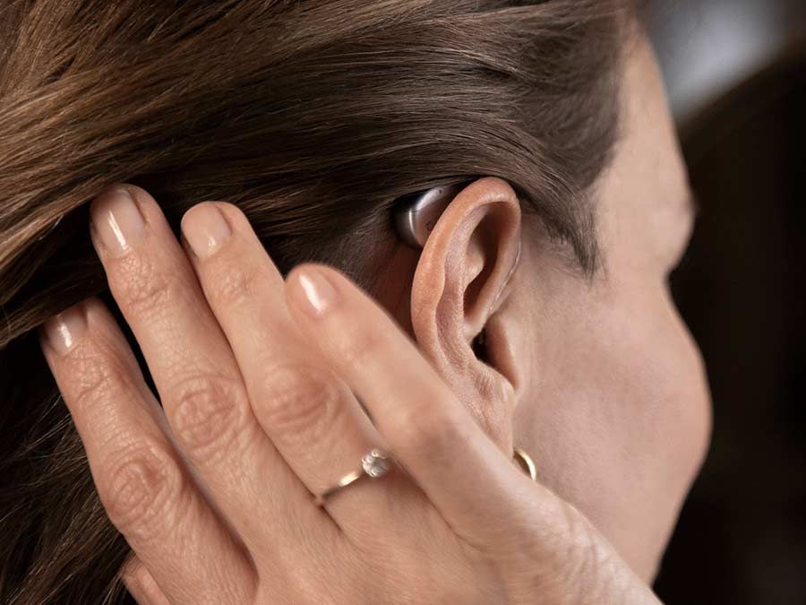 Digital Bluetooth hearing aid being worn by a patient at Pinnacle Hearing Care in Ireland