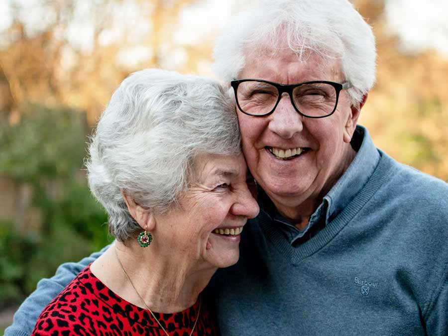 A happy couple wearing hearing aids from Pinnacle Hearing Care